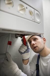 worker repairing boiler